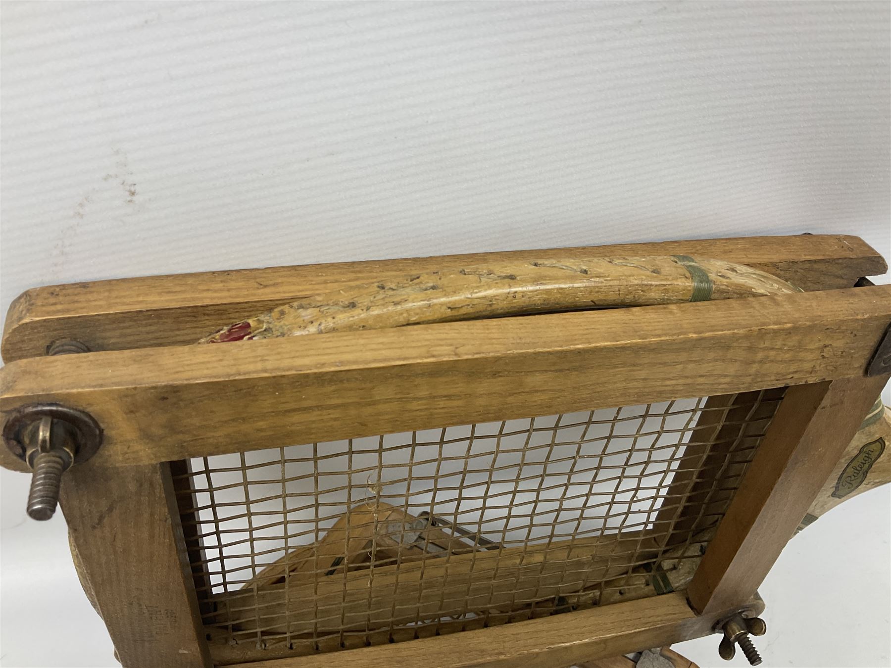 Quantity of early 20th century and later tennis rackets, to include Artus Majesty, Dunlop Alpha, Atlas Silver Shield and Raleigh Konni, together with a stitched rugby ball