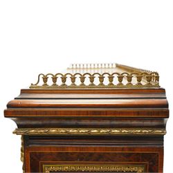 Fine late 19th century Aesthetic Movement ebony and amboyna cabinet on stand with parcel-gilt detail, the moulded cornice with pierced gilt-brass three-quarter gallery above a pair of panelled doors centred by oval porcelain portrait plaques within gilt-metal ribbon-tied frames, the doors further enriched with gilt-metal foliate mounts and flanked by classical figural terms, enclosing a shelved interior, the projecting lower section with amboyna top above a frieze drawer set with a series of floral porcelain roundels within pierced gilt-metal mounts and a central oval floral plaque, raised on turned and fluted supports with gilt-heightened detail, the mirrored back behind two amboyna shelves with pierced gilt-brass galleries, on turned feet