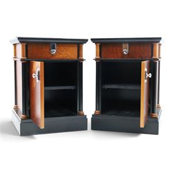 Pair of Art Deco design burr walnut and ebonised bedside cabinets, rectangular inset tops with raised rear galleries, each fitted with a drawer above a cupboard, flanked by cylindrical columns, on plinth bases