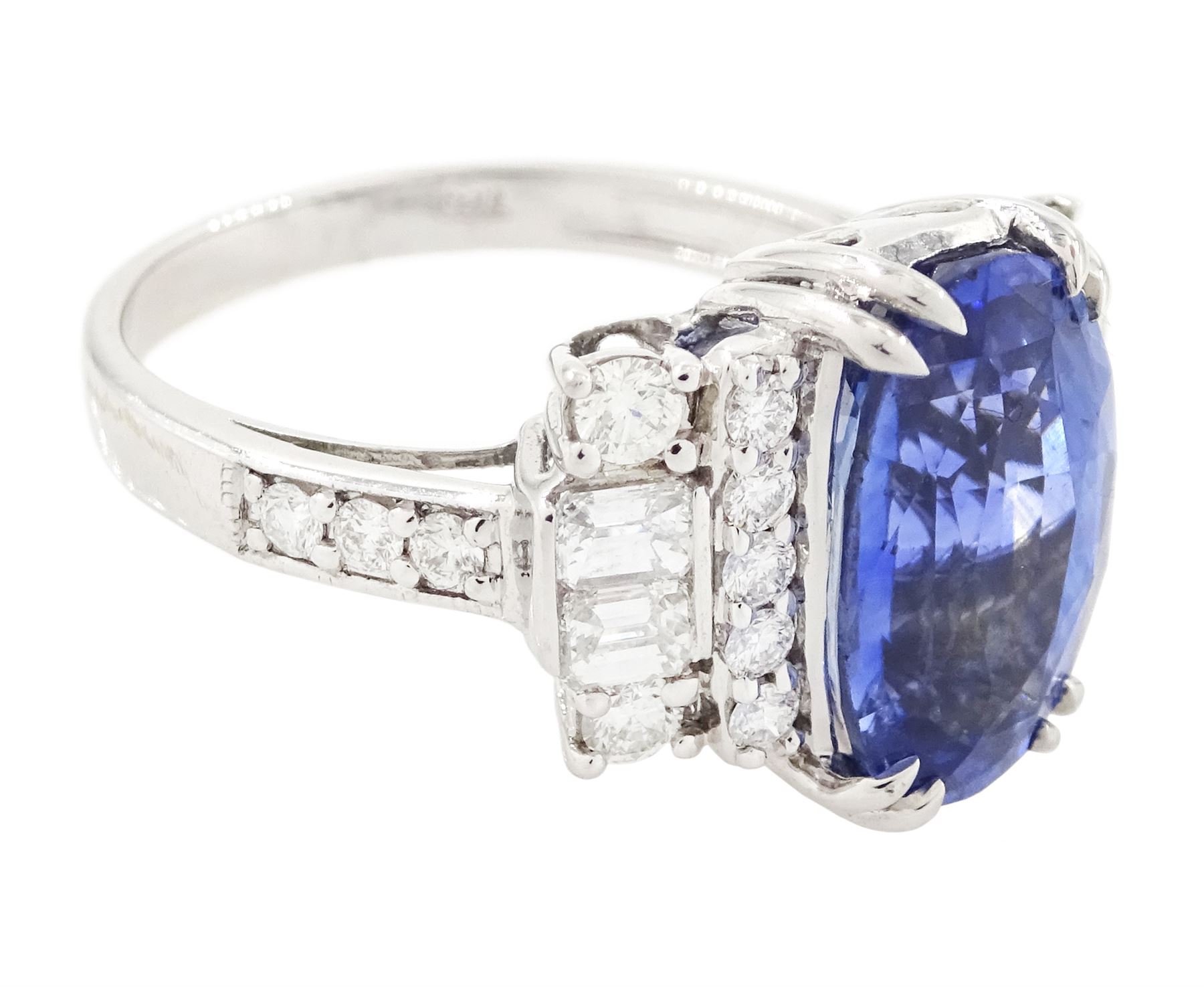 18ct white gold Ceylon sapphire and diamond dress ring, single oval cut sapphire of 4.65 carat, either side set with round brilliant cut and baguette cut diamonds and diamond set shoulders, stamped 750, total diamond weight 0.77 carat, with World Gemological Institute report