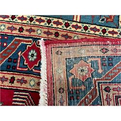 Persian Bakhtiari crimson ground carpet, the field divided into seventy panels decorated tree of life motifs, mihrabs and stylised plants, the border decorated with repeating circular medallions formed of Hac motifs, floral pattern guard stripes 