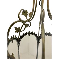19th century brass and clear glass hexagonal hall lantern, with scrolling wire work open domed top over six arched panels, including a hinged door, the base enclosed with a circular glass panel on turned feet, H64cm