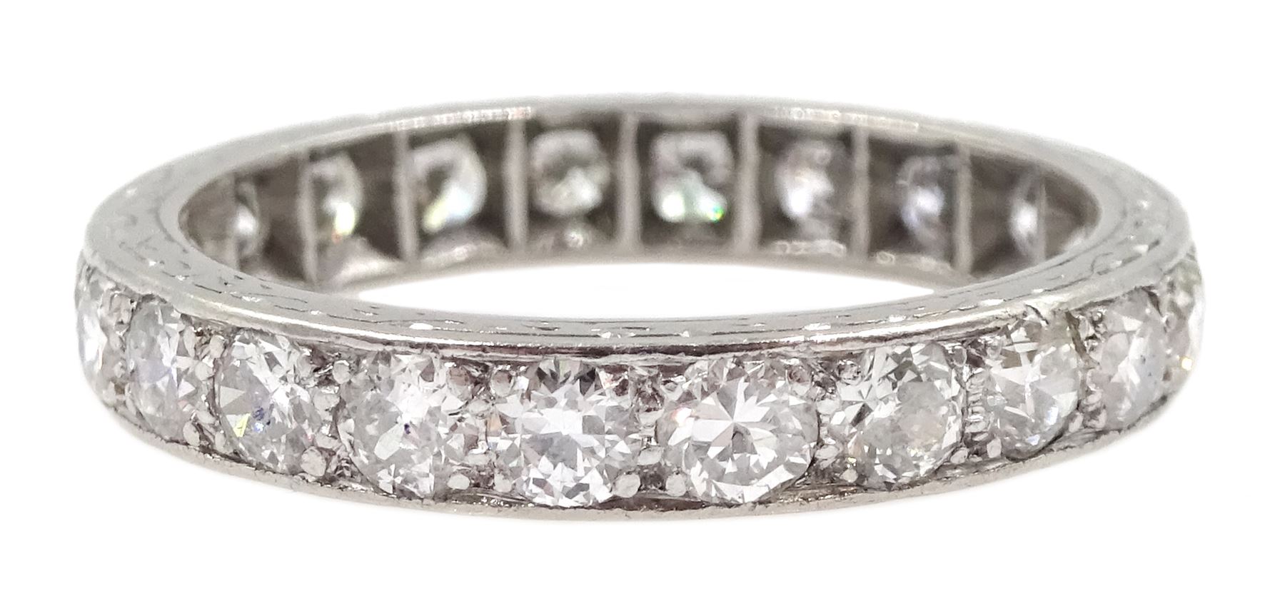 Early-mid 20th century platinum old cut diamond full eternity ring, twenty two diamonds of approx 0.06 carat, total diamond weight approx 1.30 carat, engraved decoration to the sides