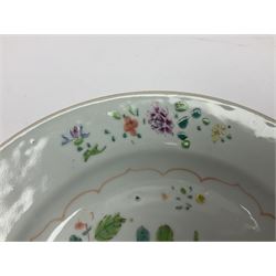 Three 18th century Chinese Famille Rose plates, the first example enamelled with blossoming peonies, rockwork and fence, the other two examples of similar design, decorated with blossoming peonies and sprigs within shaped inner borders, each approximately D23cm