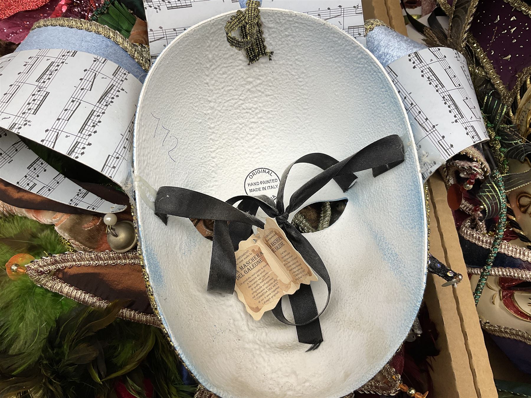 Large collection of decorative Venetian masks, to include two bearing tags for La Maschera Del Galeone, in two boxes 