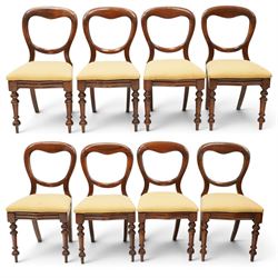 Set of eight mahogany balloon-back dining chairs, drop-in seats upholstered in yellow patt...