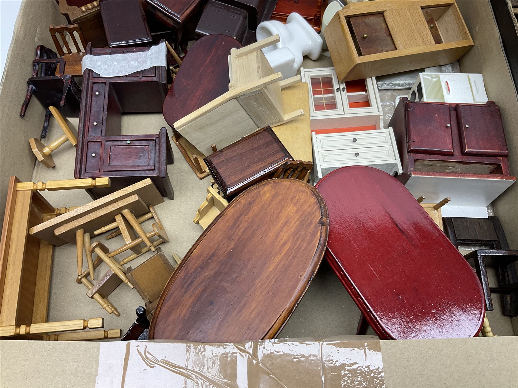 Large quantity of 1970s doll's house furniture, predominantly stained or painted wooden, including lounge, dining room, kitchen and bedroom pieces, bathroom fittings, bureaux and desks, piano, lamps, fire-surrounds etc; various scales