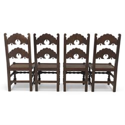 Early 20th century set of seven Jacobean Revival oak chairs, comprising pair of cavers and five chairs, each with carved mask and scroll decoration to the crest and and back rail, plain oak seat, upon turned front legs and block rear legs with conforming stretchers