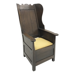 18th century Yorkshire Dales oak lambing chair, shaped cresting rail above panelled wing back, panelled sides and front, drop in upholstered seat cushion, W65cm, H111cm, D80cm