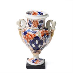 19rh century German porcelain centrepiece with pierced cover decorated with applied flowers and figures at the base H31cm,  near pair of scent flasks with applied flowers and a two-handled vase
