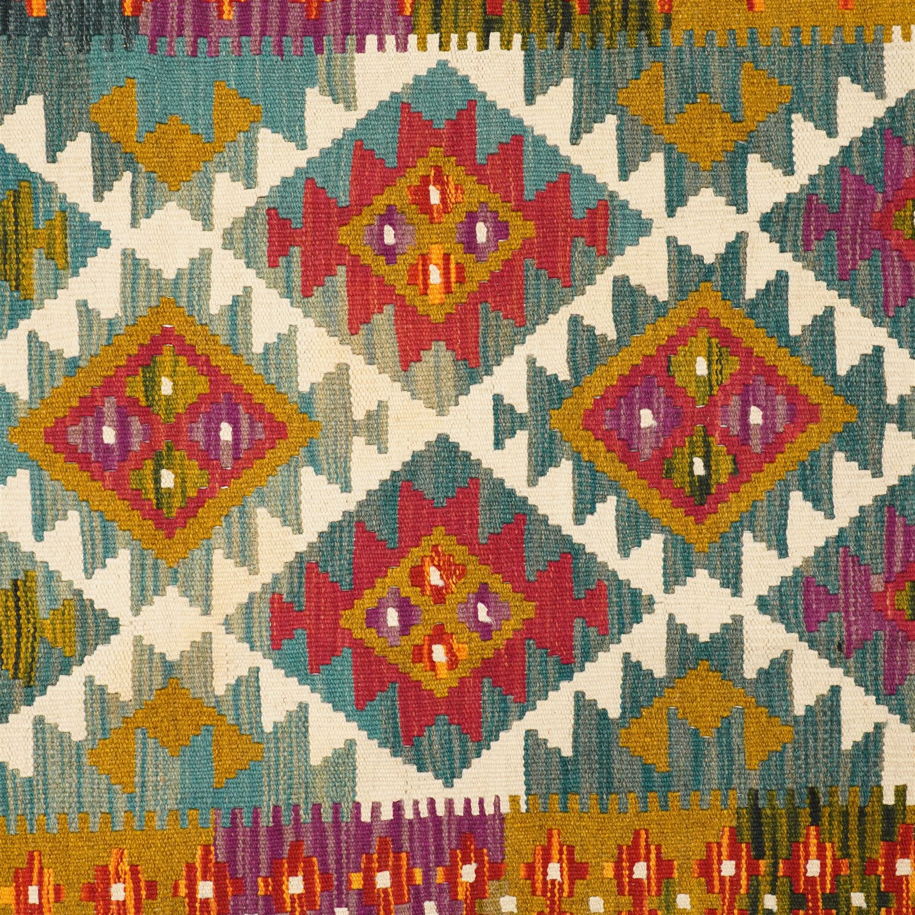 Afghan Maimana flatweave kilim runner, central field features large bold nested diamond motifs and stylized geometric lozenge patterns on olive purple, ochre, blue, and green tone ground, border stripe in orange and crimson ground, and fringe
