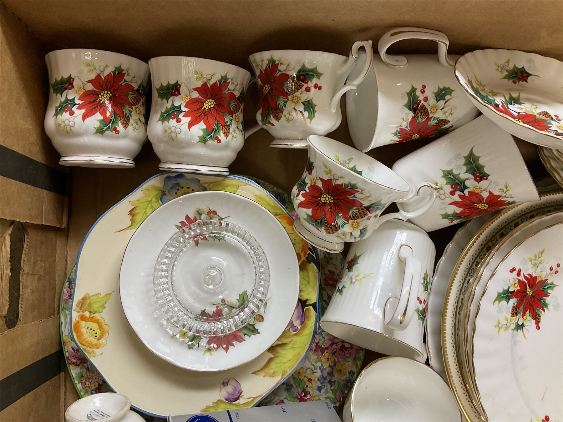 Royal Albert Poinsettia pattern part tea service, including tea cups, mugs, dessert plates, cake plate, together with James Kent plates, Crown Staffordshire Vermouth ceramic decanter label, glassware etc, two boxes 