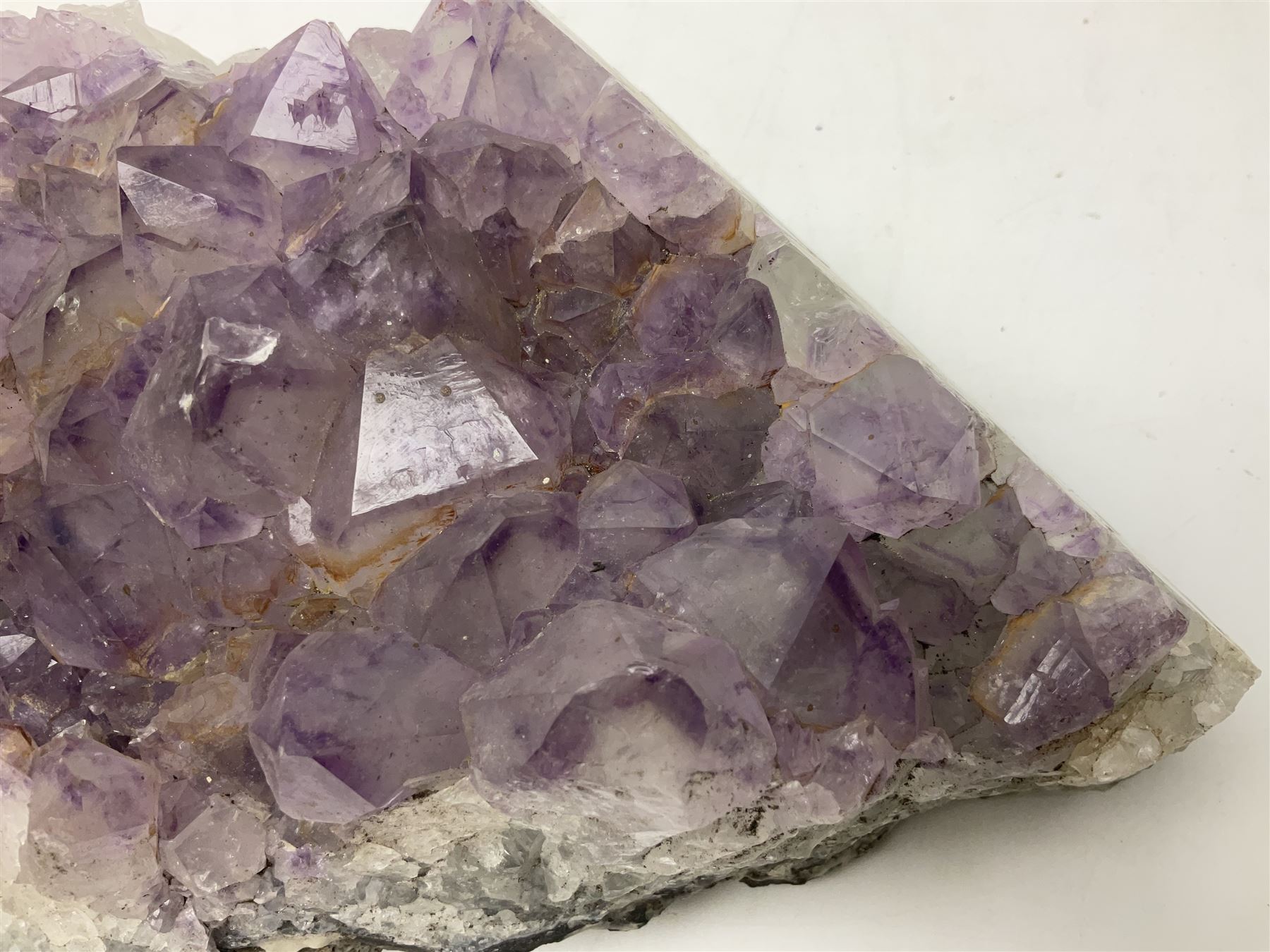 Amethyst crystal geode cluster, with well-defined crystals of various sizes, H10cm, L30cm