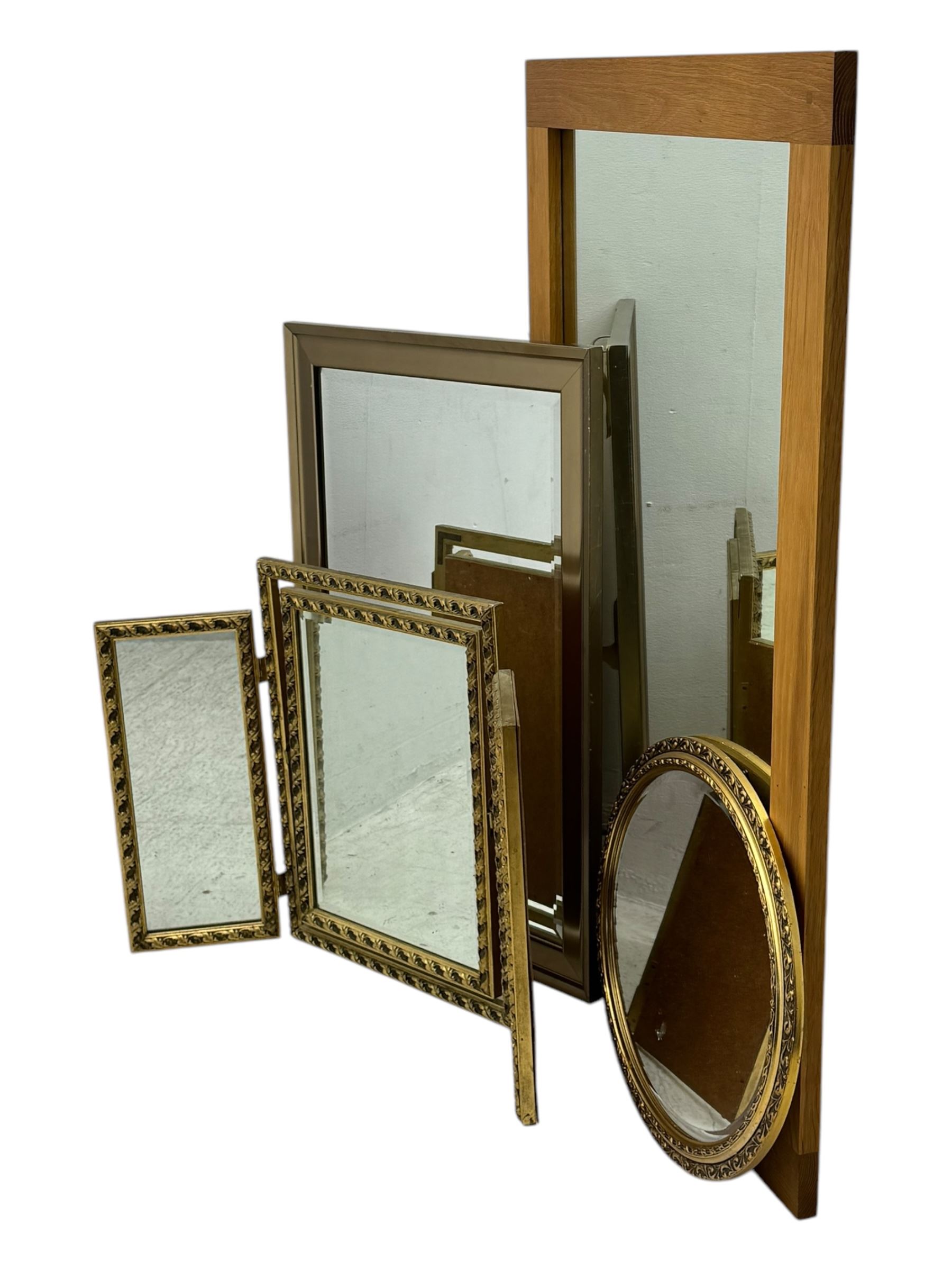 Four decorative mirrors, including gold-toned triptych dressing mirror with foliate borders, two rectangular framed mirrors and a circular gilt mirror with ornate edging