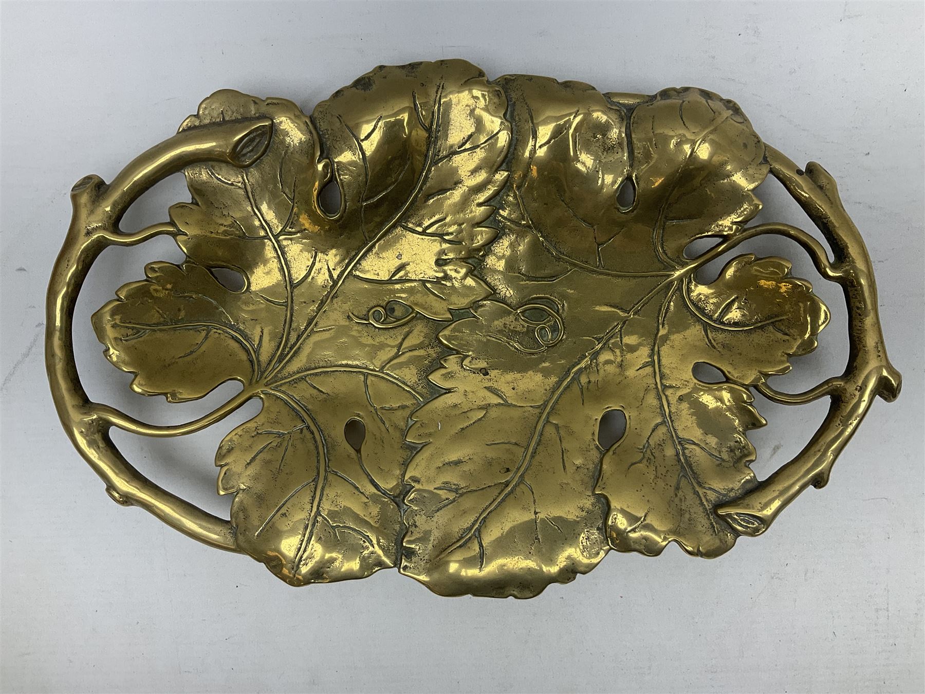 Late 19th/early 20th century twin handled brass centrepiece dish in the form of oak leaves, raised upon four legs, L37cm