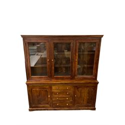 Large hardwood display wall unit, the upper section fitted with three glazed doors enclosing six shelves, the lower section fitted with four central drawers flanked by two panelled cupboards