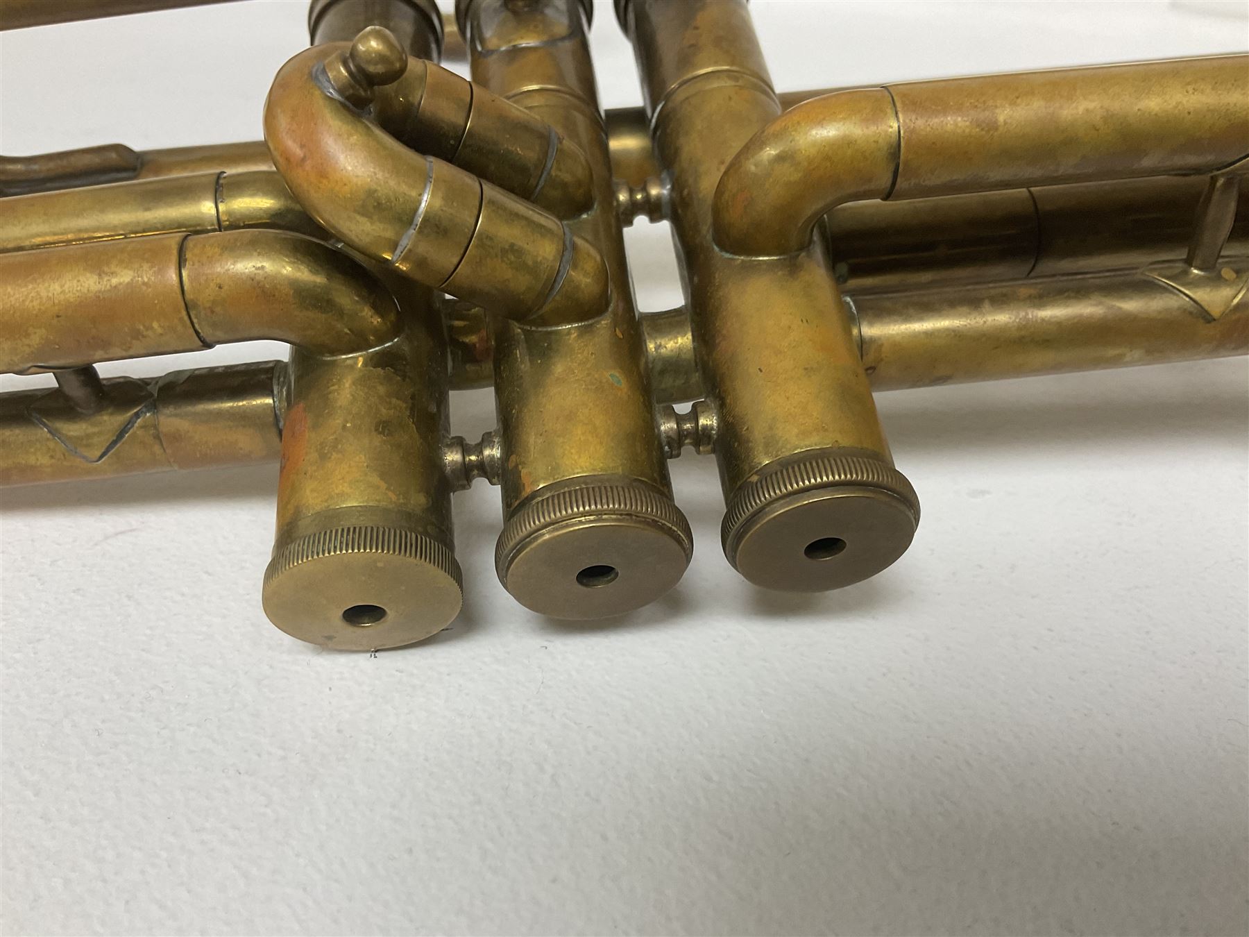 Three brass trombones comprising Elkhart Ind. USA 'CONN' model no.72H; Besson 'Concord'; and Selmer Distributed 'Lincoln'; two in carrying cases; and German B & M 'Champion' brass trumpet (4)