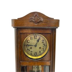 German -1930s oak wall clock, striking the hours and half hours on a gong.