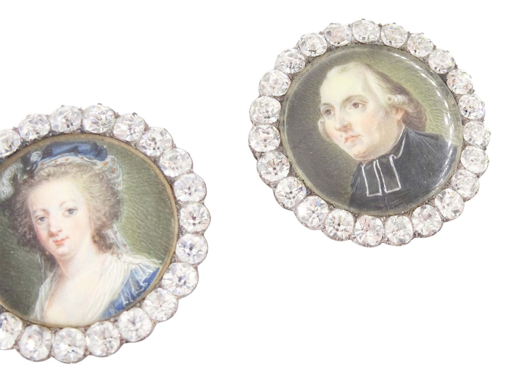 Set of six late 18th century French portrait miniature buttons, each finely painted upon ivory with a likeness of notable figures of the French Royal Court, set under glazed panels within silver frames mounted with paste stones, engraved verso with the sitters’ names and fitted with eyelets, later adapted with suspension rings; comprising “LE ROY” (Louis XVI), “LA REINE” (Marie Antoinette, youth portrait), “LA REINE” (Marie Antoinette, mature portrait), “MADAME” (Maria Josepha of Savoy, 1771–1810, wife of Louis, Comte de Provence, later King Louis XVIII), “M. BAILLY” (Jean Sylvain Bailly, 1736–1793, Mayor of Paris), and “M. L’ABBÉ MAURY” (Jean-Siffrein Maury, 1746–1817, Cardinal and Archbishop of Paris), overall D3.5cm. This lot has been registered for sale under Section 10 of the APHA Ivory Act