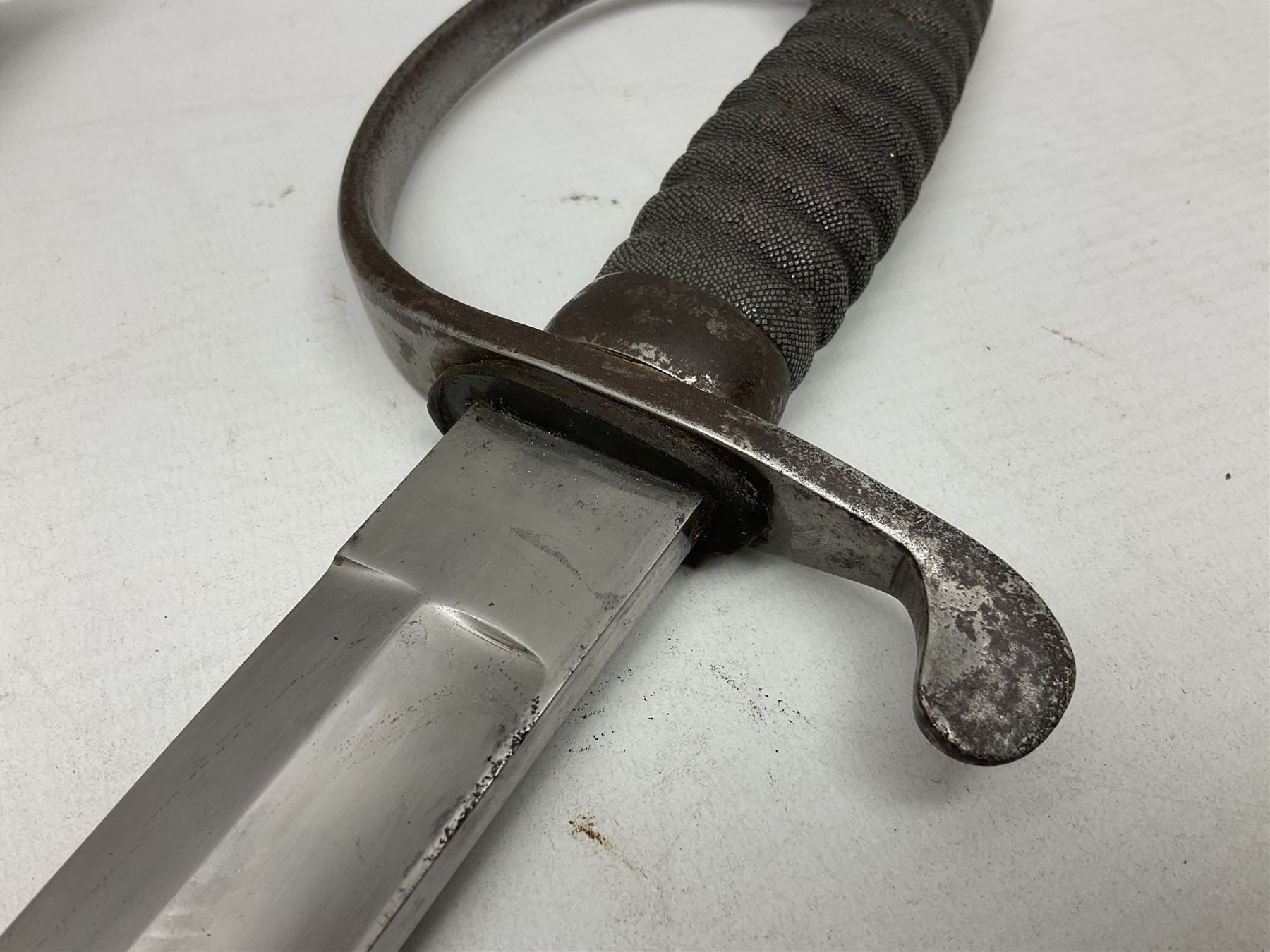 Mid-19th century Custom’s officer/Constabulary sidearm, with plain 60.5cm slightly curving fullered blade double edged at tip,  steel knucklebow and downswept quillon, stepped pommel and ribbed fishskin grip; in leather covered scabbard with steel locket, frog stud and chape L76cm overall