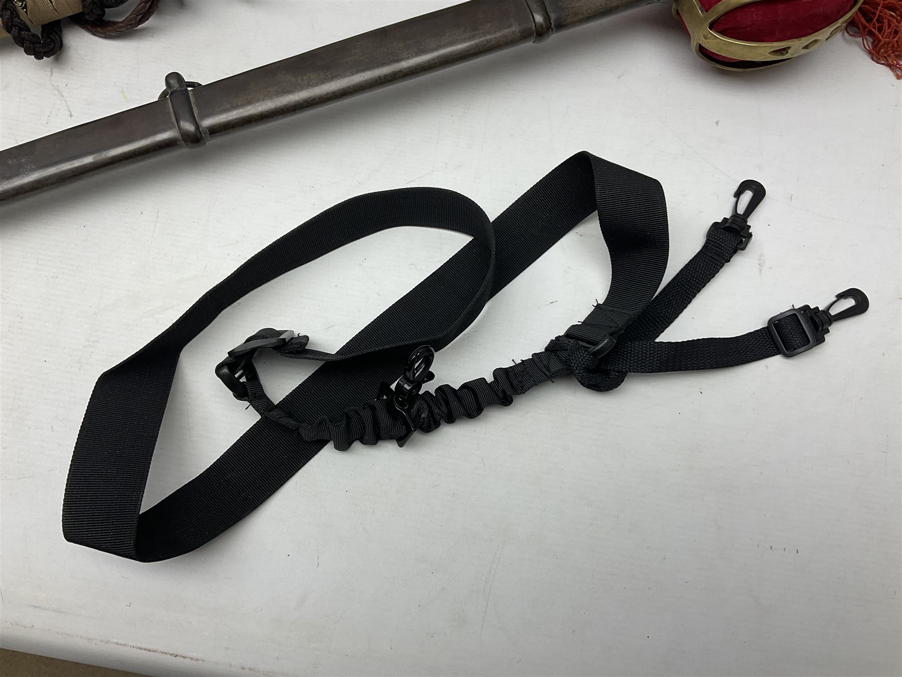 Reproduction Scottish officers basket hilt broad sword, the brass basket pierced with heart-shaped motifs lined with red lining, together with a reproduction Japanese Katana sword, longest L110cm