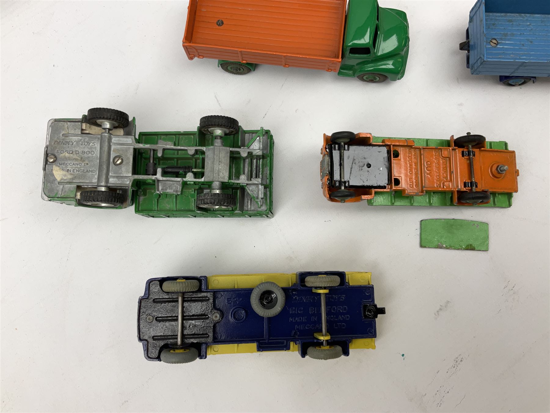 Dinky - seven unboxed and playworn/repainted die-cast commercial vehicles comprising Bedford Articulated lorry, Leyland Comet, Big Bedford, Ford 800 tipper truck, Guy flatbed and planked flatbed lorries and Dodge tipper truck (7)