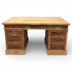 Late 19th century Victorian pine twin pedestal desk, rectangular plank top above an arrangement of seven drawers with brass swan neck handles, each pedestal fitted with one drawer above a double height drawer, raised on plinth bases with panelled sides
