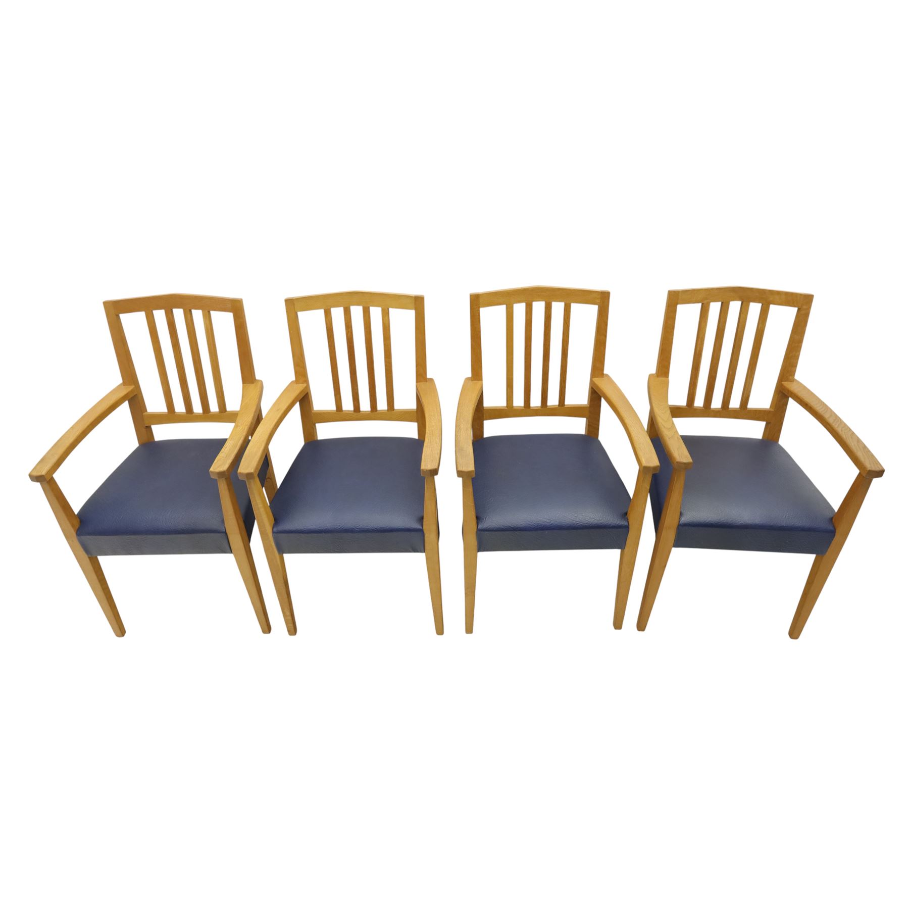 Modern twelve oak dining chairs including one 'Chairmans' chair, solid oak construction, slatted back and arm rests, blue leatherette padded seat, on tapered square supports 