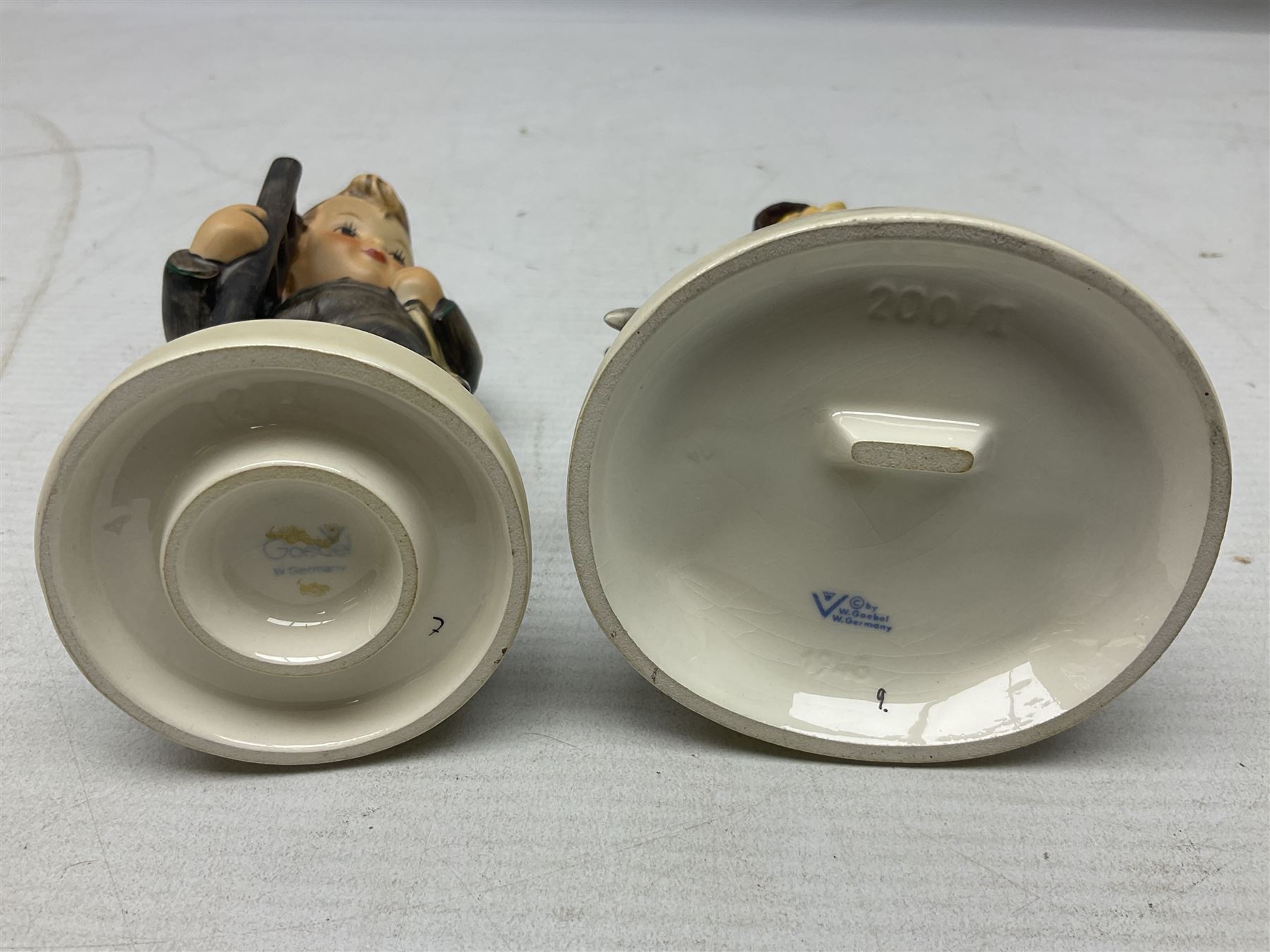 Seven Goebel Hummel figures, comprising Chimney Sweep 12/I, Apple Tree Girl 14/I, Apple Tree Boy,  Little Goat Herder 200/I, Surprise 94 3/0, Signs of Spring 203/20 and Wayside Harmony 111/30, tallest H15cm