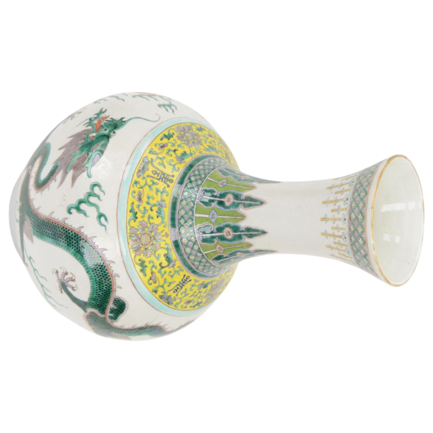 Pair 20th century Chinese famille verte bottle vases, each decorated with green and purple dragons chasing pearls amidst auspicious flames, the neck with yellow and green stylised foliate and cell borders, and the white glazed body incised throughout with fan shapes, each with red character mark beneath flanked by green dragons, H38cm

