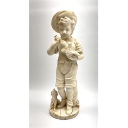 A Victorian alabaster figure modelled as a young boy holding bird, with dog at his feet, H41cm. 