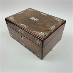 A Victorian rosewood vanity box, with inlaid foliate mother of pearl decoration, the hinged cover opening to reveal a compartmented interior with two glass scent bottles, and two glass pots with silver plated lids, L30.5cm. 
