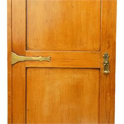 Late 19th century Arts & Crafts stained pine single hall wardrobe, single panelled door with brass fittings enclosing sliding tray to top with hanging rail and hooks, hinged box seat to base, on compressed bun feet