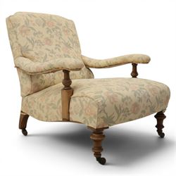 Victorian mahogany framed deep seat low drawing room chair, upholstered in beige floral fa...