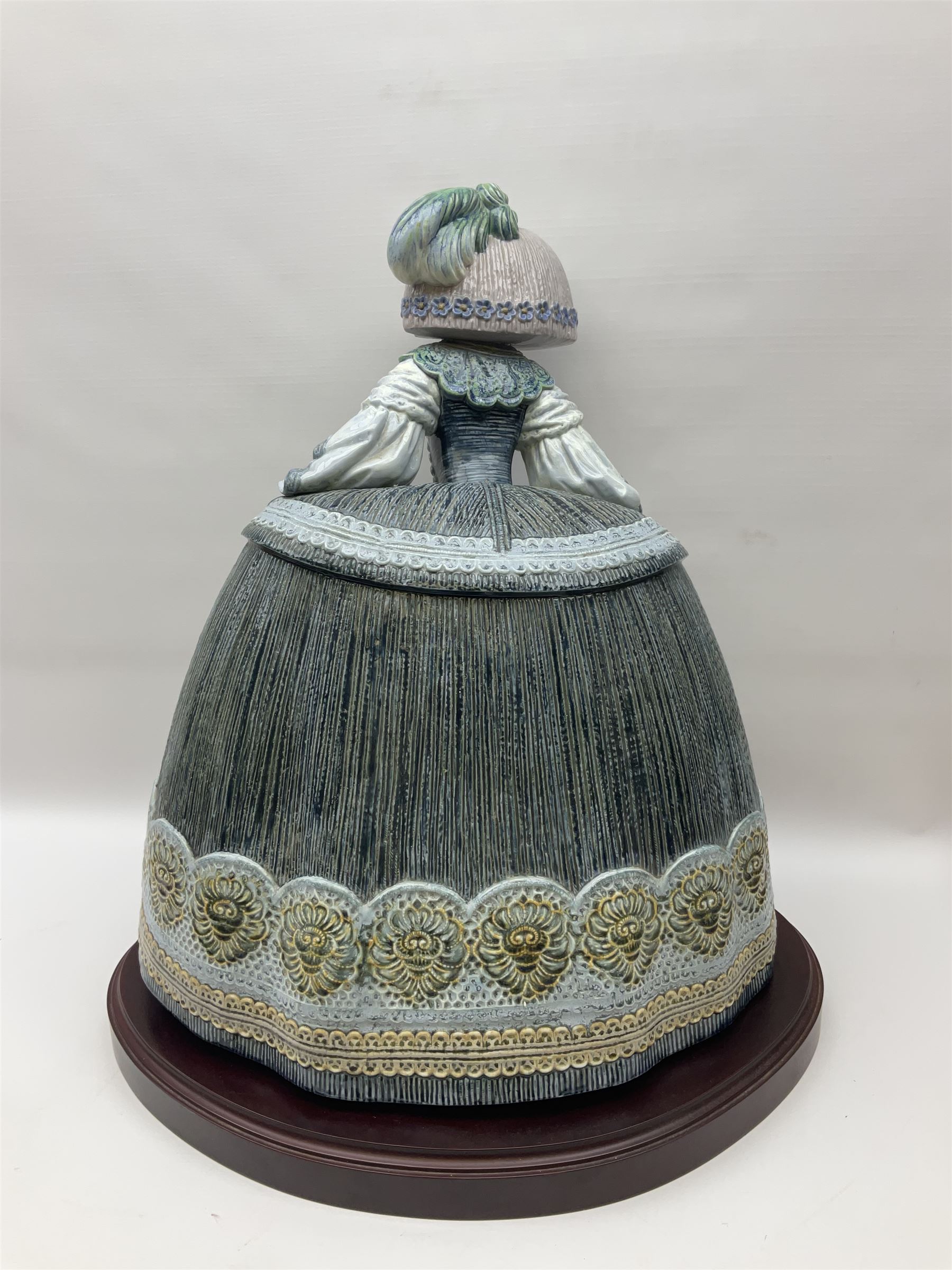 Large Lladro figure, La Menina, modelled as a maid of honor in service, on a mahogany oval base, limited edition 99/1000, sculpted by Jose Puche, with certificate of authenticity, framed and glazed, no 1812, year issued 1996, year retired 2019, H60cm