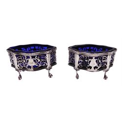 Pair of Victorian open silver salts with pierced sides, upon four ball and claw feet, hallmarked George Nathan & Ridley Hayes, Chester 1900, H5.2cm, each with blue glass liner