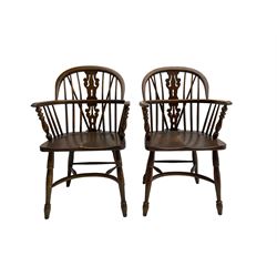 Pair late 20th century oak Windsor elbow chairs, double hoop and stick back with pierced and fretwork work splat, dished seat on turned supports joined by crinoline stretcher