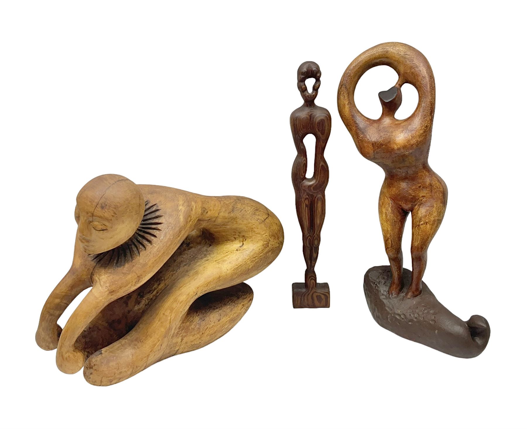 Helen Skelton (British 1933 – 2023): Three carved wooden abstract sculptures, each modelled as a a figure, tallest H52cm. Born into an RAF family in 1933 in Kent and travelled the world extensively during her childhood. After settling in Bridlington, Helen immersed herself in painting, textiles, and wood sculpture, often inspired by nature's beauty. Her talent was showcased in a one-woman show at Sewerby Hall and recognised with the sculpture prize at Ferens Art Gallery in 2000. Sadly, Helen’s daughter passed away from cancer in 2005. This loss inspired Helen to donate her sculptures to Marie Curie upon her passing in 2023.