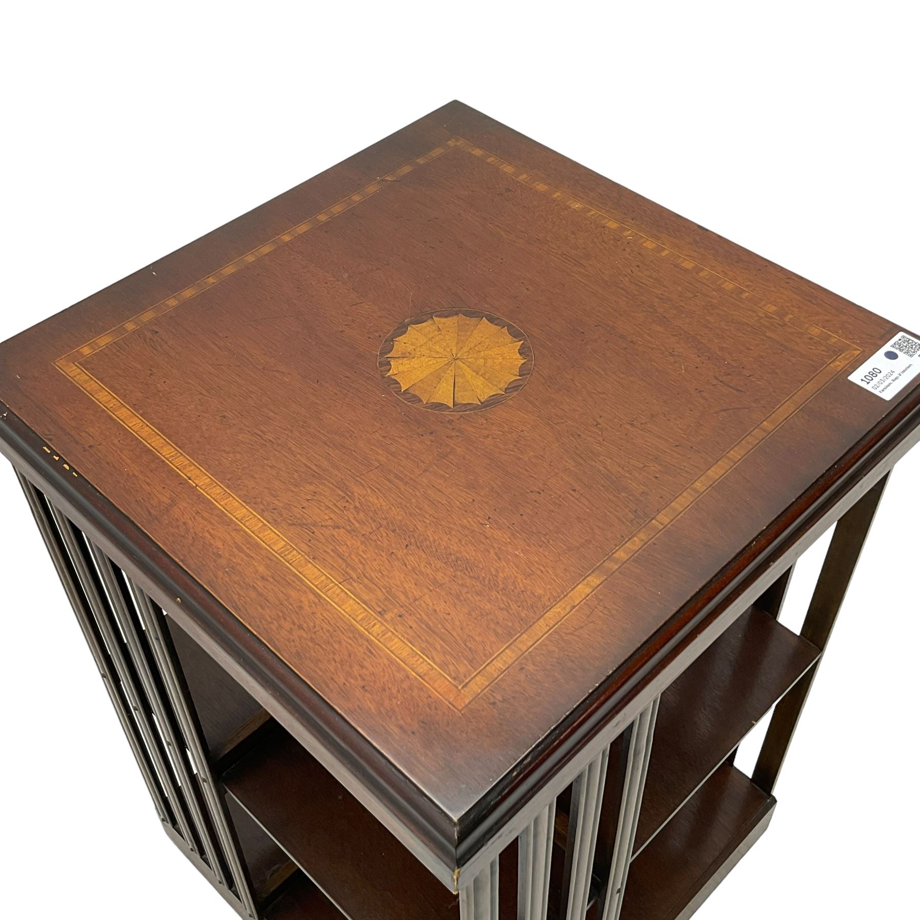 Edwardian revival inlaid mahogany revolving bookcase, square form with moulded top inlaid with central fan motif, two-tiers with moulded upright rails, on castors 