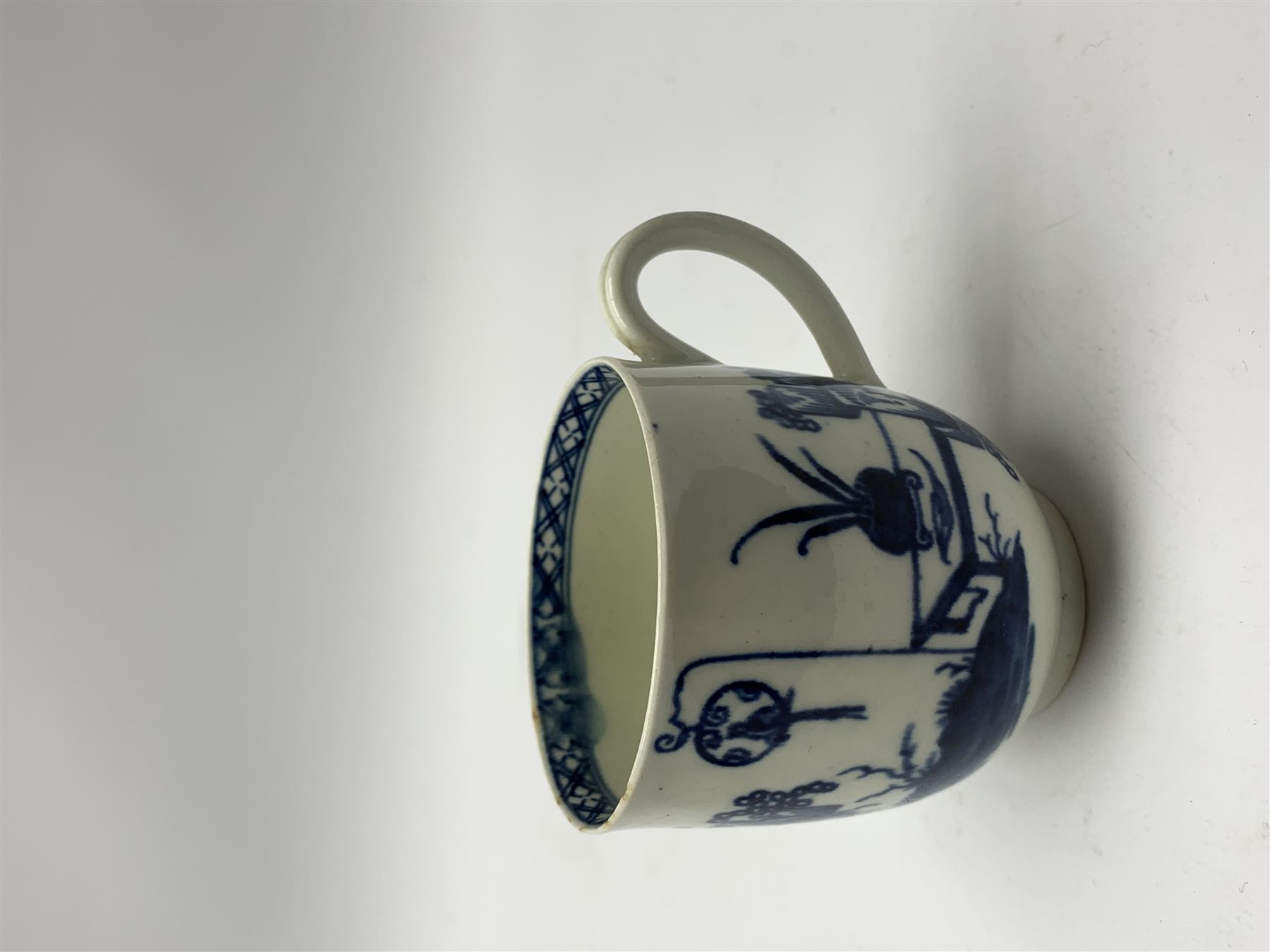 18th Century Worcester teapot, circa 1765-70, decorated in the Bird in the ring pattern, the cover with bud finial, with crescent mark beneath, H13cm, together with a Worcester coffee cup decorated in the same pattern, with crescent mark beneath, H6.5cm