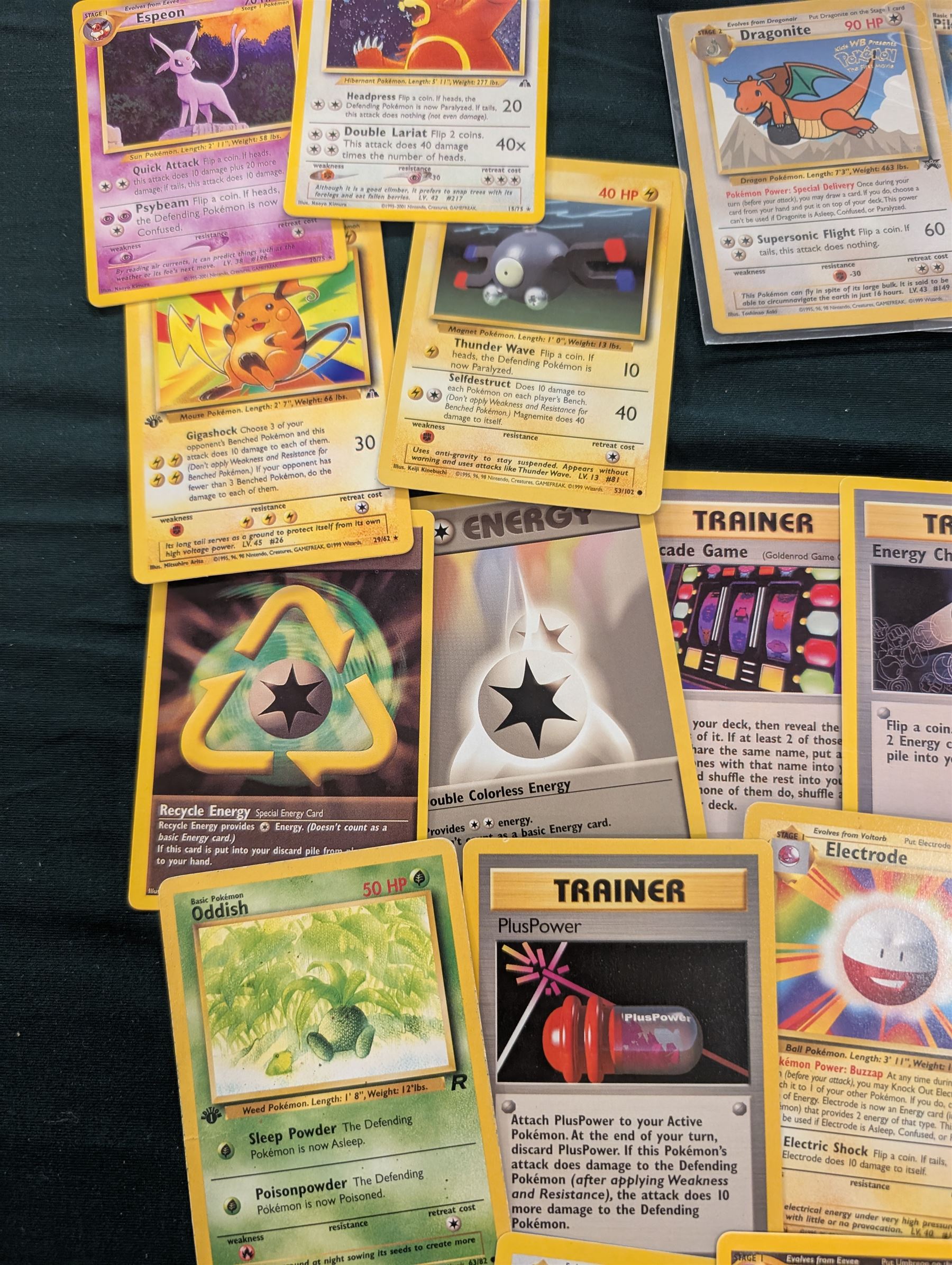 Collection of Pokemon TGC trading cards, including two WB First Movie Black Star promo cards Pikachu no. 4 and Dragonite no. 5, two Ancient Mew Black Star holo promo cards, Gym Challenge Giovanni's Persian 8/132 holo and a small collection WOTC, Neo Discovery and Neo Genesis cards, together with thirty four Bandai Carddass Pokemon cards, including prism Charizard no. 186 and Pokemon Topps cards including holo examples 