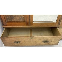 Late Victorian walnut triple combination wardrobe, projecting moulded and dentil cornice, central shaped bevelled mirror glazed door, cartouche and curled leaf carved panels over figured walnut veneered panels, fitted with drawer to base, on bracket feet