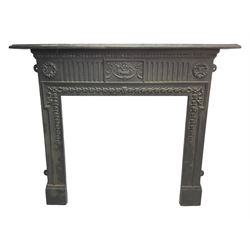 Adam design - cast iron fire surround, moulded rectangular mantel over central foliate urn and vertical flutes, flanked by C-scroll floral roundels, the aperture decorated with trailing bellflowers
