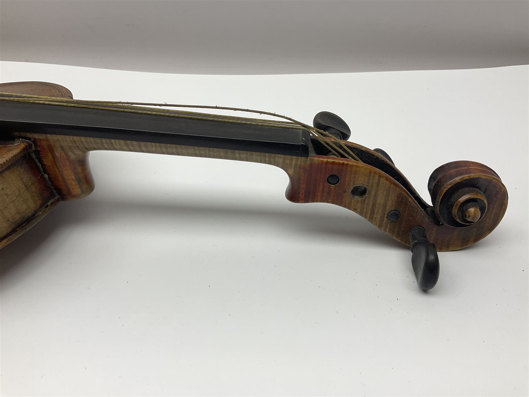 Late 19th century French three-quarter size 'Conservatory' violin with 34cm two-piece maple back and ribs and spruce top, the peg box inscribed 'Conservatory Violin Straduari', bears label 'Antonius Stradiuarius Cremonensis Faciebat Anno 1721' L55.5cm overall; in ebonised wooden 'coffin' case; and Saxony violin c1900 with 36cm two-piece maple back and ribs and spruce top; bears label 'Antonius Stradivarius Cremonensis Faciebat Anno 17**' L59cm overall; in carrying case (2)