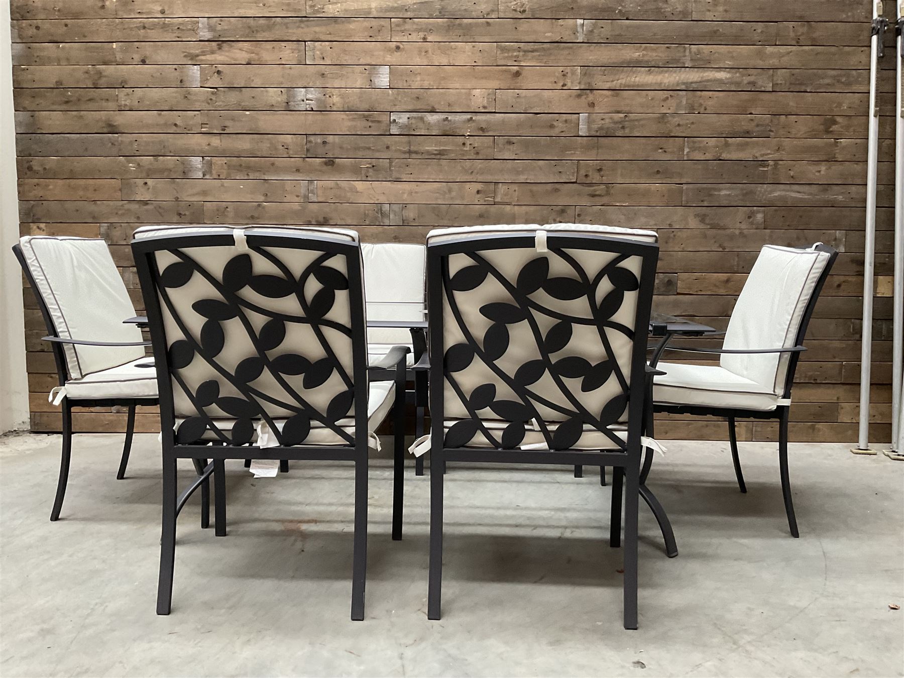 Metal framed garden table with glazed top (W170cm, D102cm, H71cm) and six armchairs with cushions 