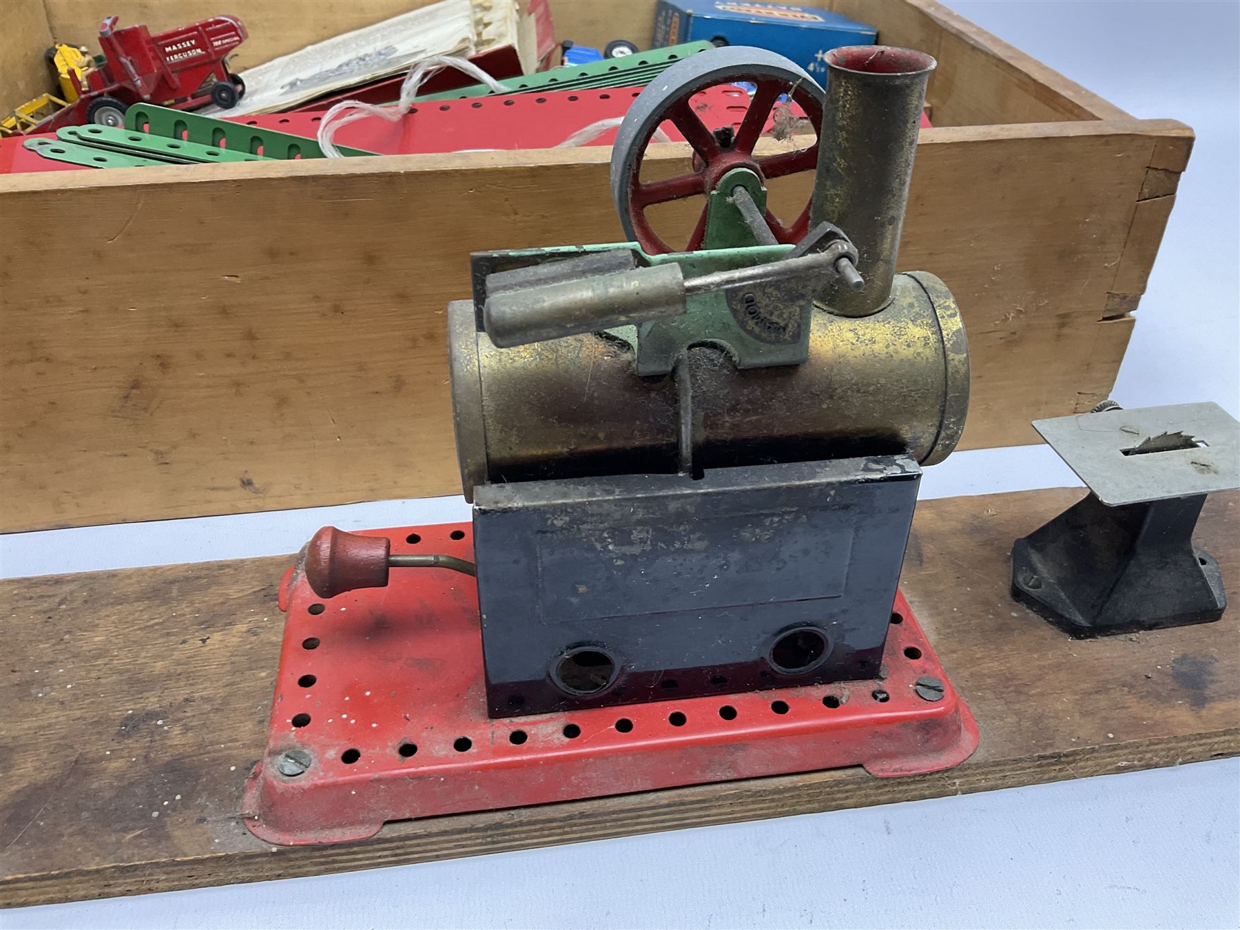 Mamod small stationary steam plant with circular saw bench and grinder mounted on long wooden board L107cm; and quantity of predominantly red/green Meccano in wooden box with die-cast models etc