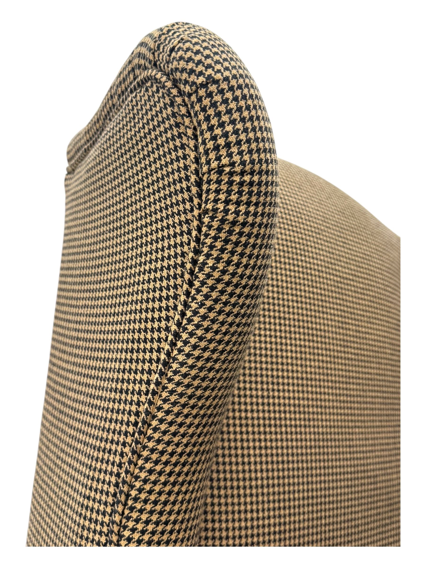 Hardwood-framed wingback armchair, upholstered in dog tooth pattern fabric, on cabriole supports 