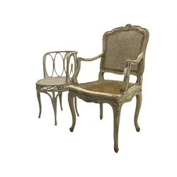 French style painted beech open armchair, with caned seat and back, carved with flower heads, cabriole supports (W58cm), and a cane work side chair
