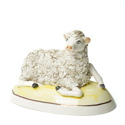 Pair of 19th century Staffordshire sheep, W13cm; together with a pearlware bocage group, H12cm (3)