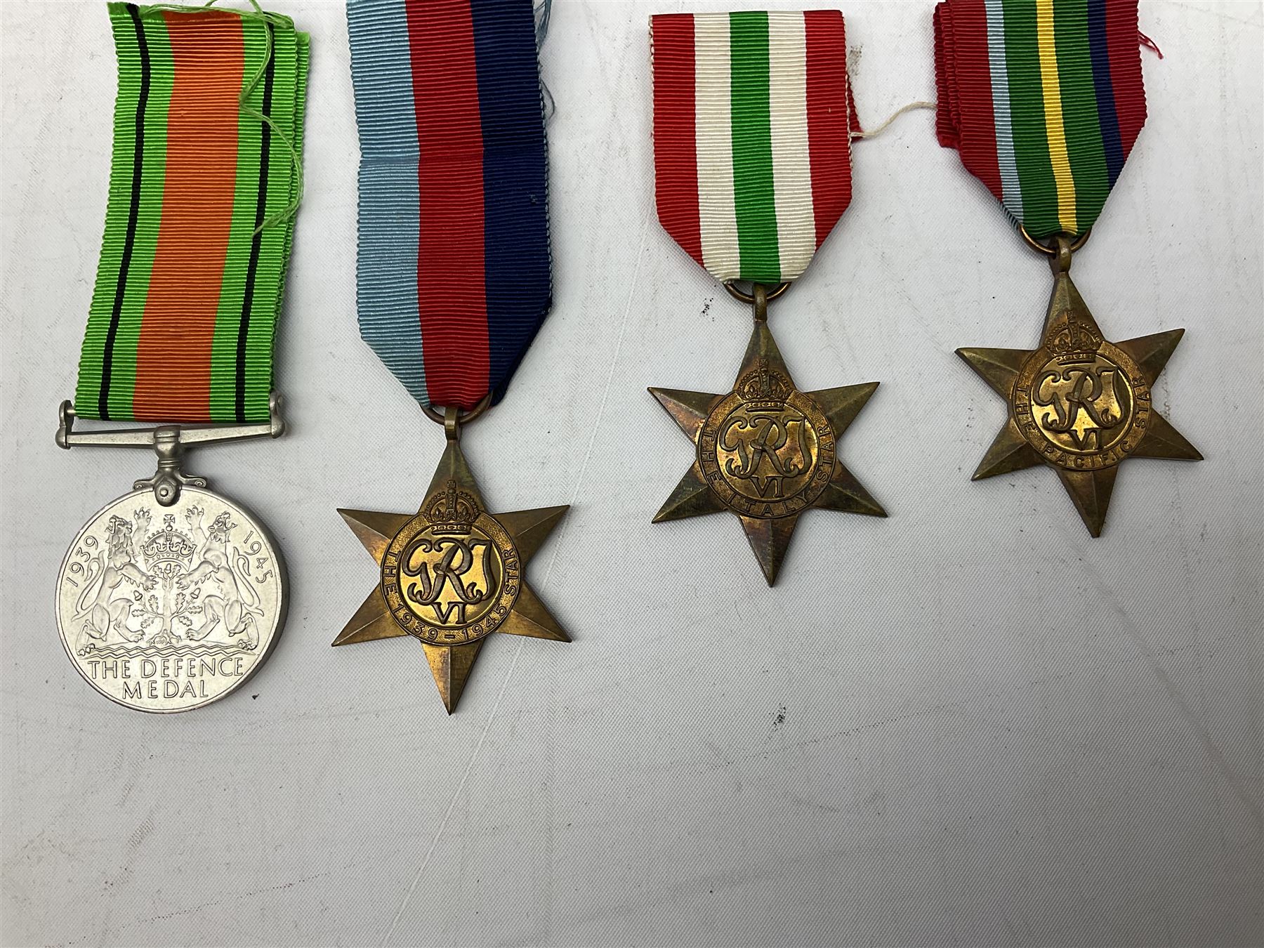 Eight WW2 medals comprising two War Medals 1939-1945, two Defence Medals, Atlantic Star, Italy Star, Pacific Star and 1939-1945 Star; all with ribbons (8) 